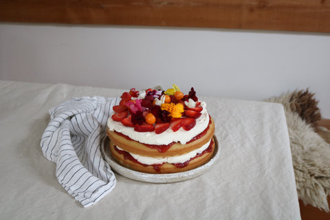 Victoria sandwich cake with fresh fruit and flowers